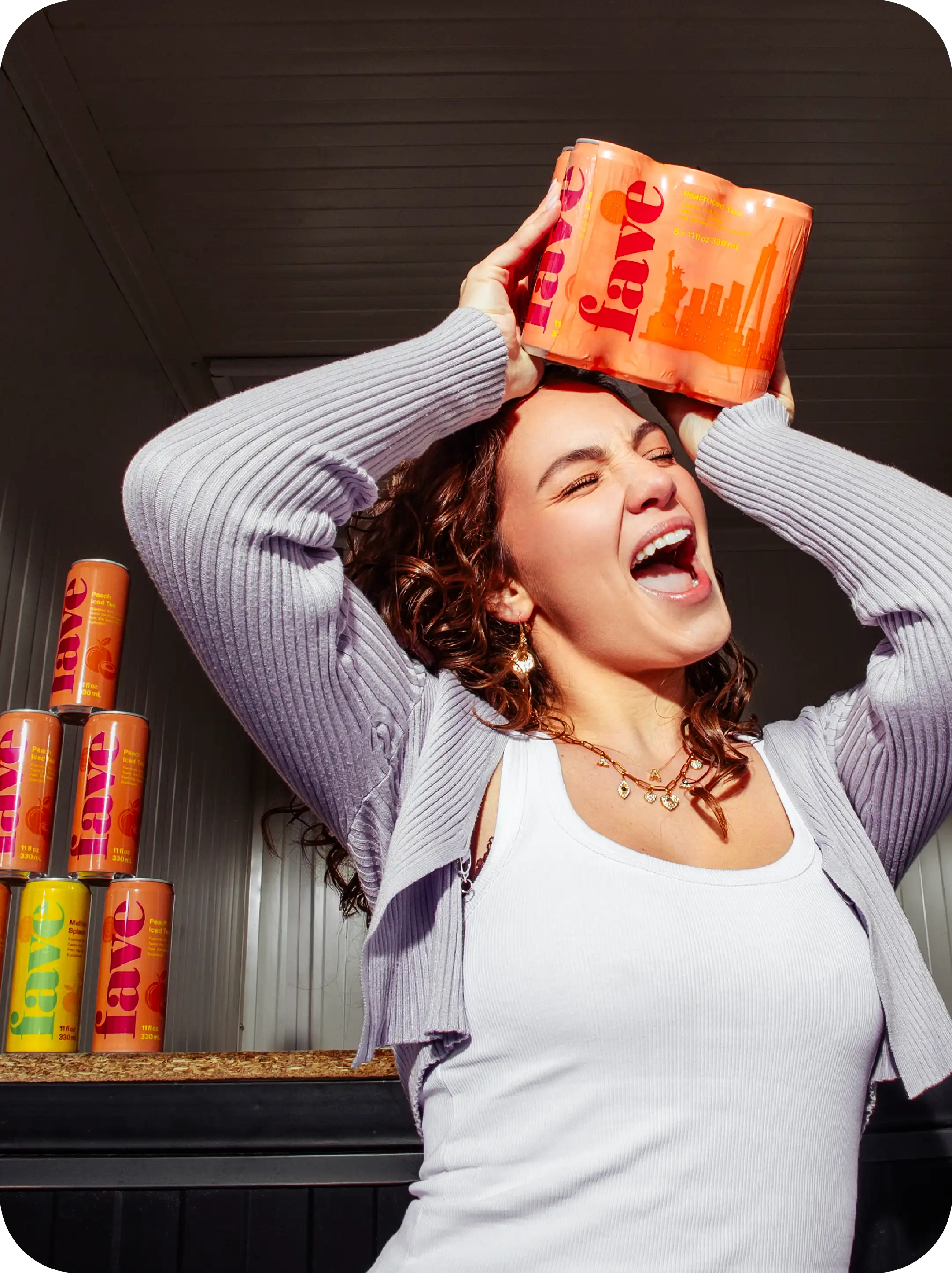 Woman balancing a six-pack of Fave on her head