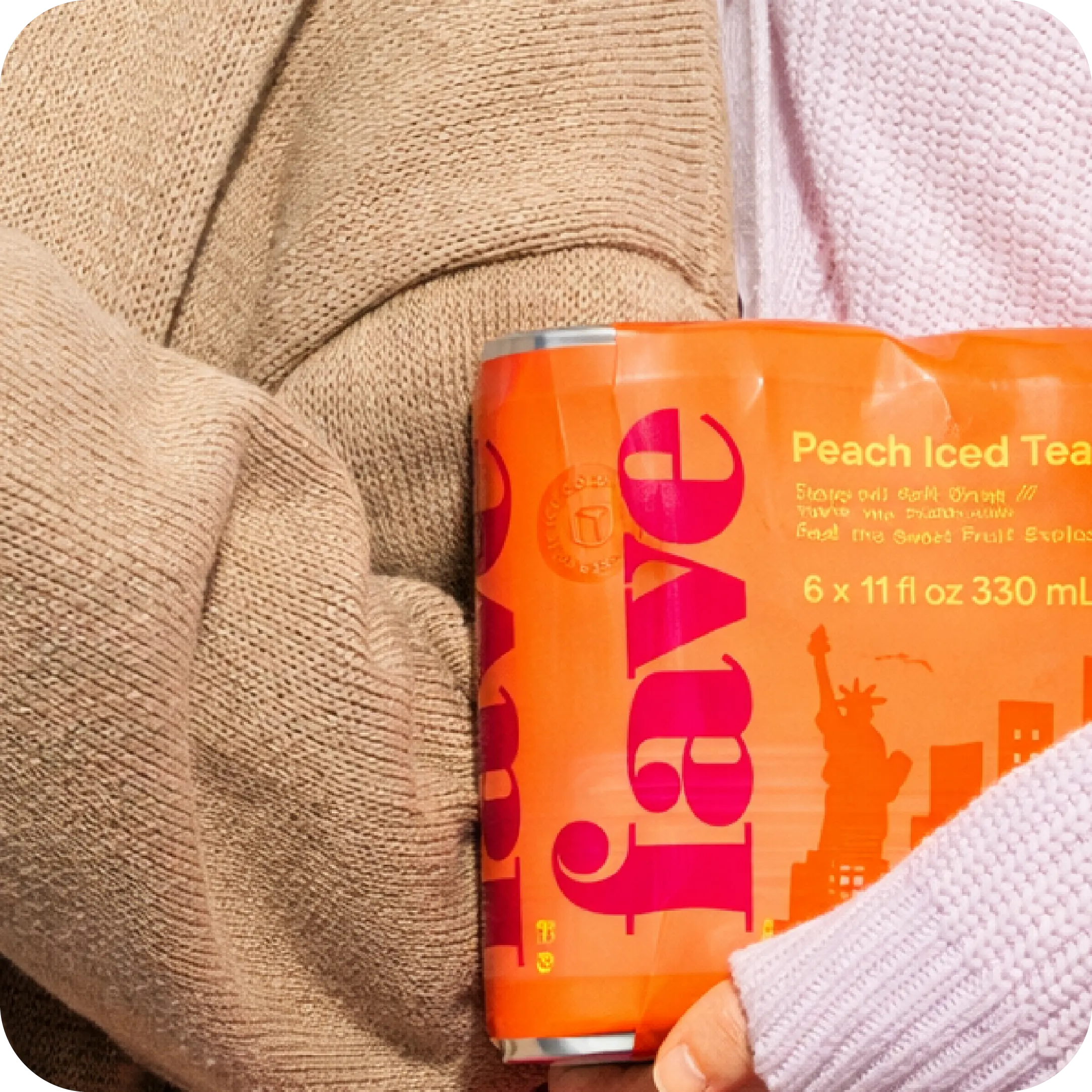 Holding a Fave Peach Iced Tea six-pack